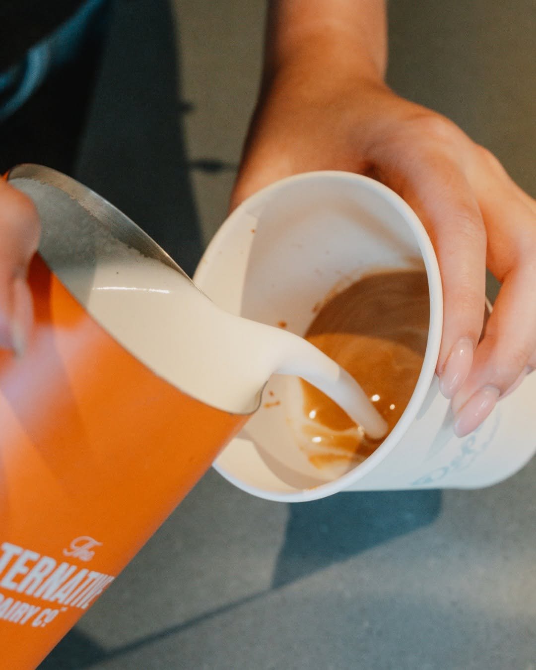 Milk being poured into coffee at Depot Cafe & Lounge