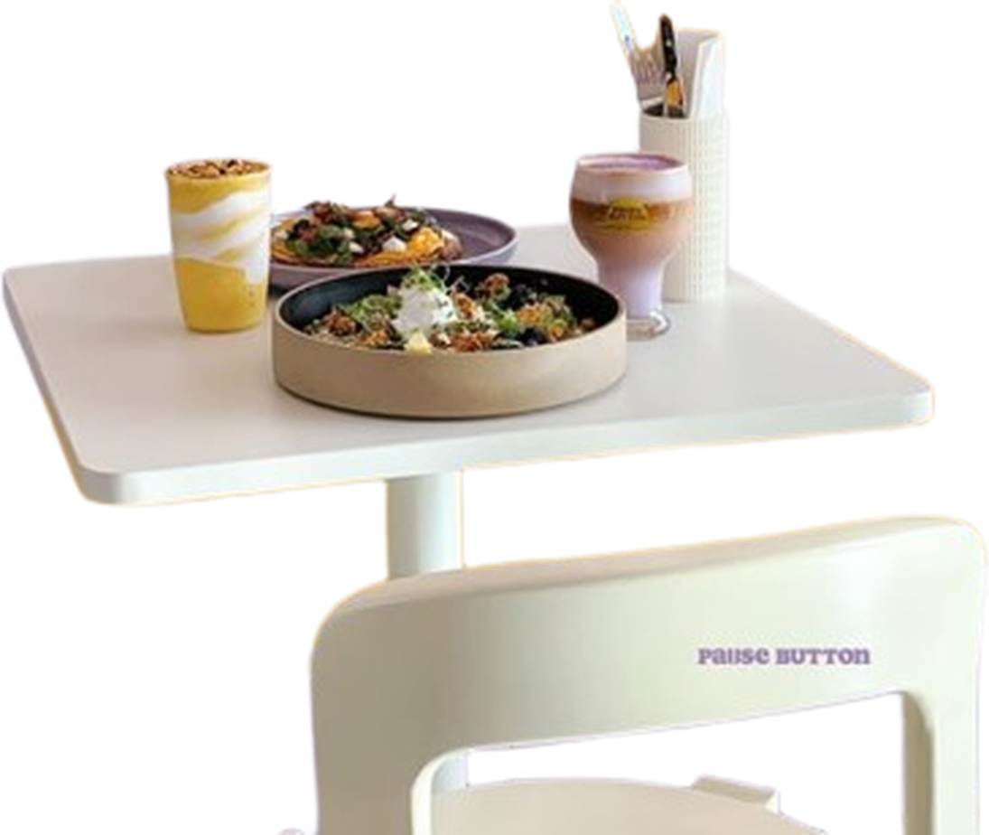 Pause Button table with food, drinks, and chair